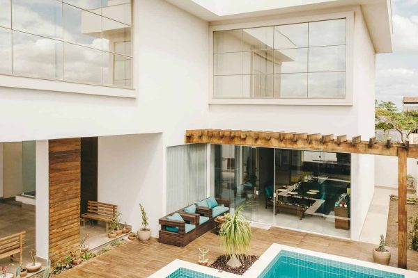contemporary-interior-of-lounge-area-with-swimming-pool-located-on-terrace-of-luxury-villa-in-sunny-day-5563472-scaled